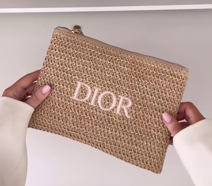 Tan Dior raffia clutch bag.