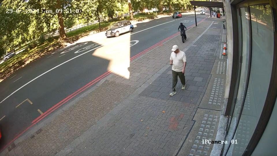 CCTV footage of a phone theft: A man's phone is snatched by a thief on an e-bike.