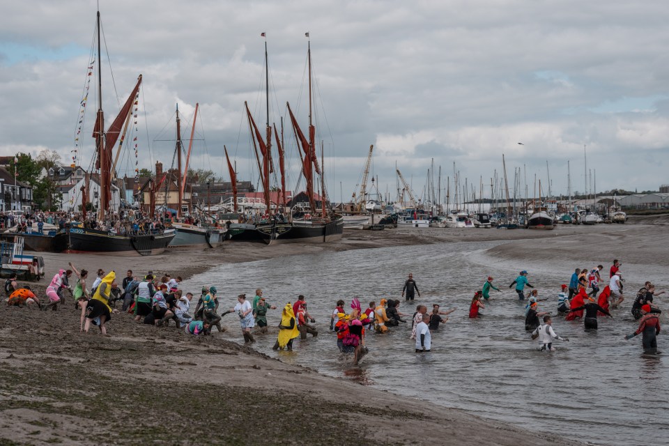 Competitors in costume participate in the Maldon Mud Race.