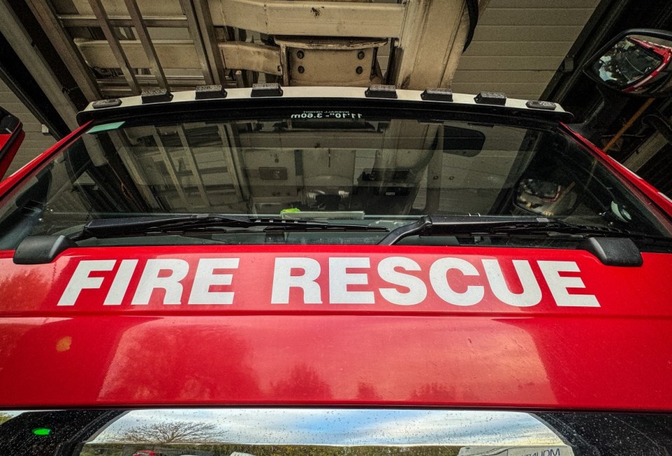 Close-up of a fire rescue vehicle's hood with "FIRE RESCUE" in white lettering.