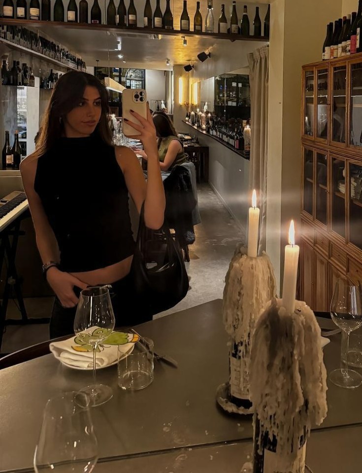 Mirror selfie of a woman in a Barcelona wine bar.