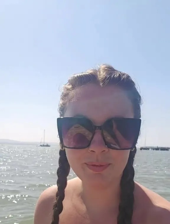 Woman in sunglasses by the water, text overlay: "MY DISPOSABLE INCOME"