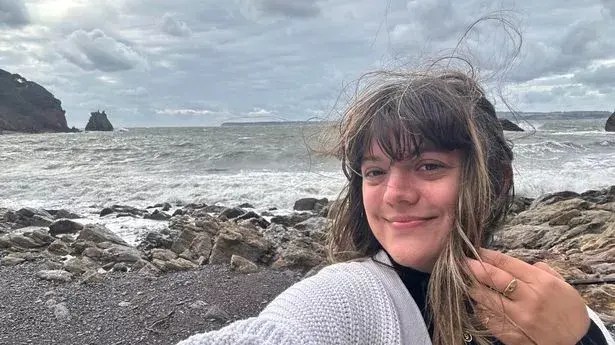 Woman taking a selfie at the beach.