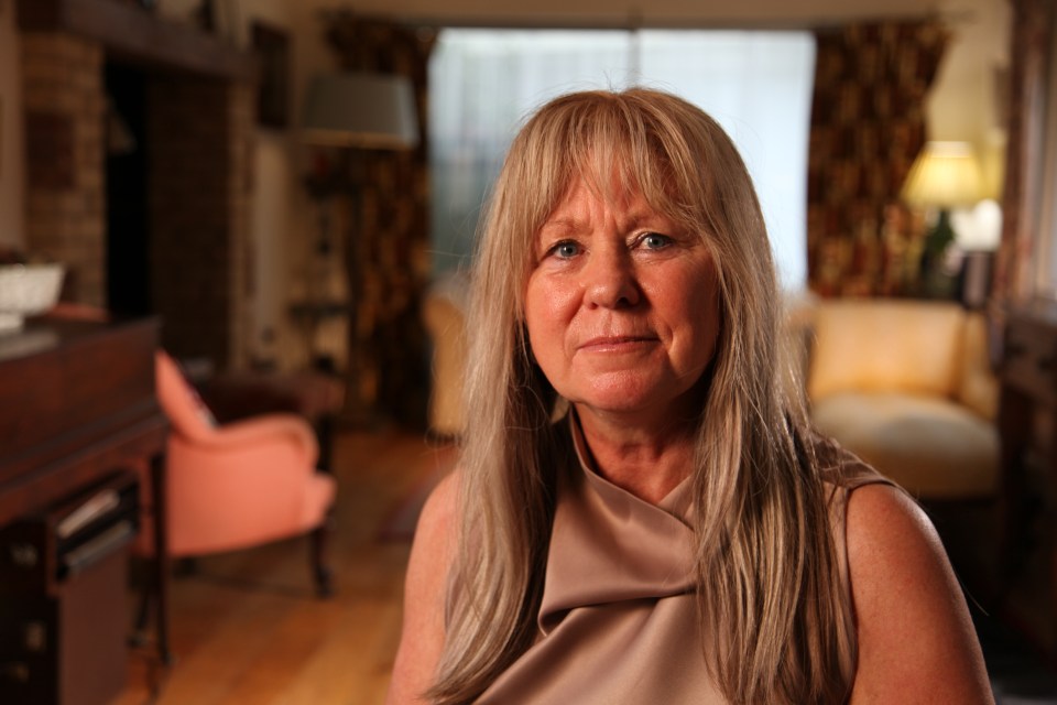 Portrait of a woman with long blonde hair.