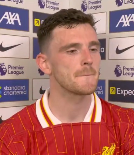 Robertson in a Liverpool jersey, appearing emotional in an interview.
