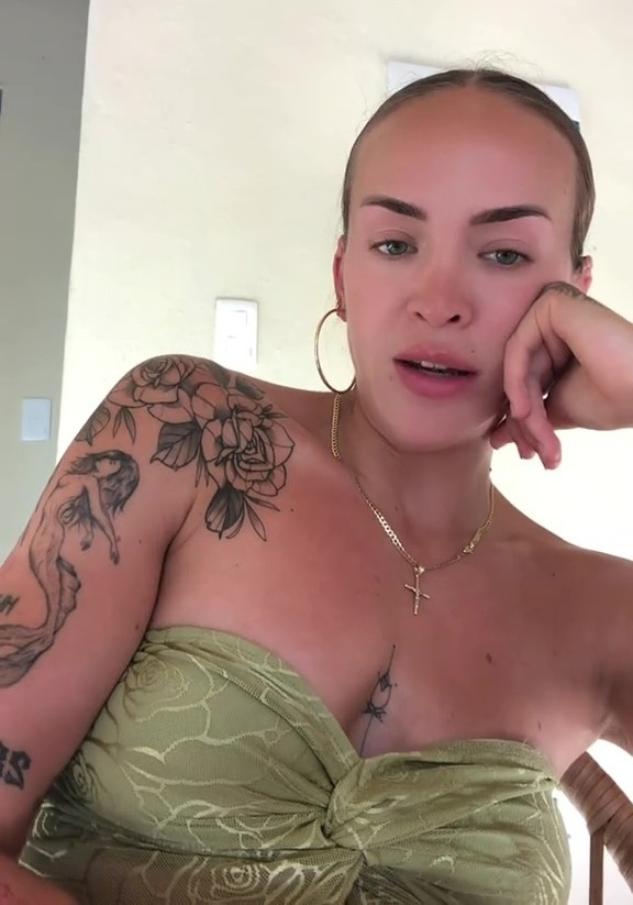 Woman with tattoos speaking to camera.