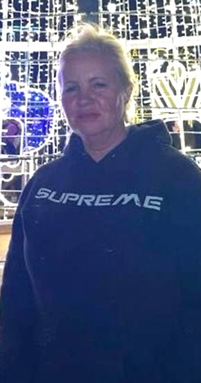 Woman wearing a Supreme hoodie.