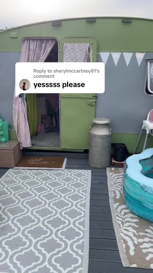 A green caravan in a backyard, decorated for children.