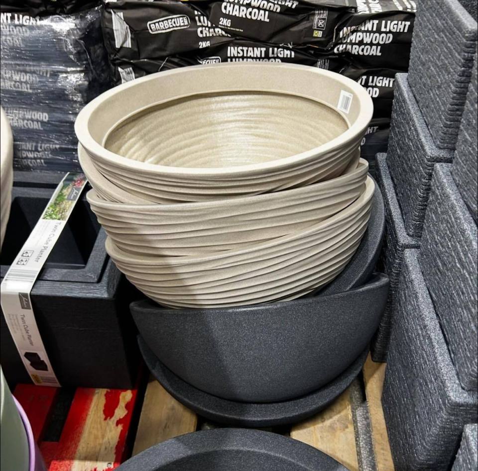 Stack of beige and dark gray planters.