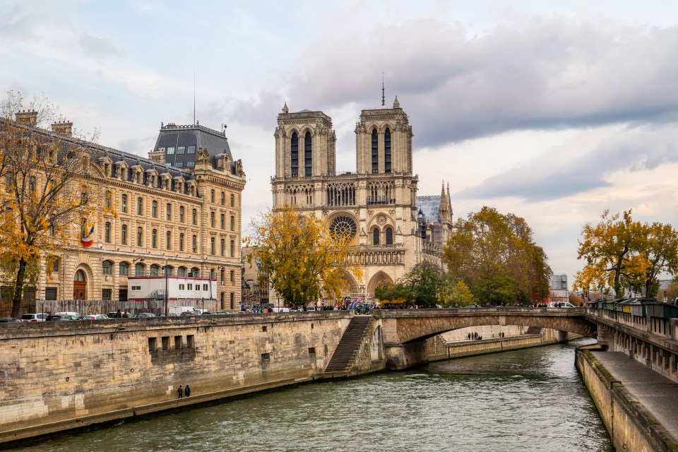 Notre Dame Cathedral in Paris, France, viewed from across the Seine River.