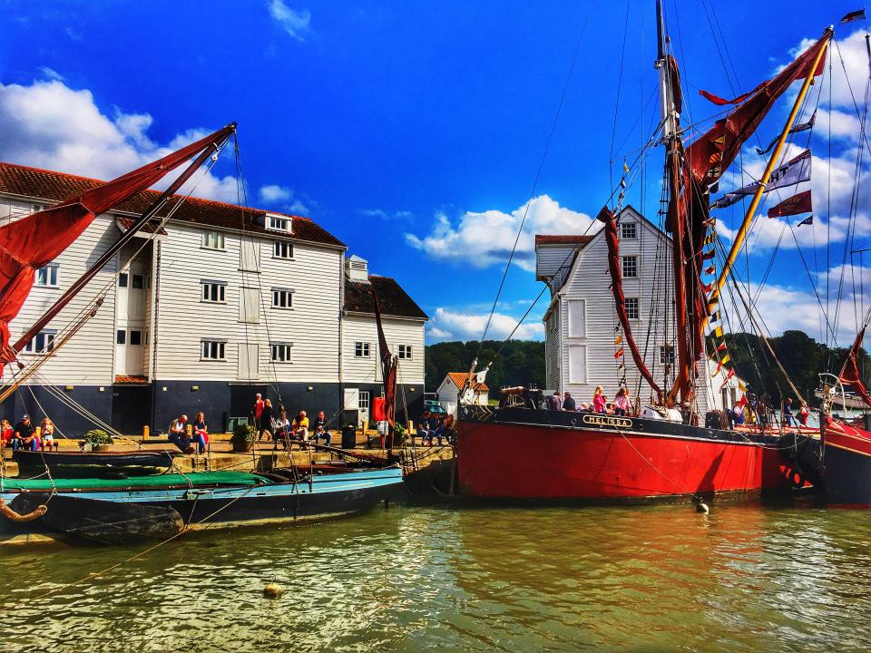 Sailing boats docked at a waterfront building.