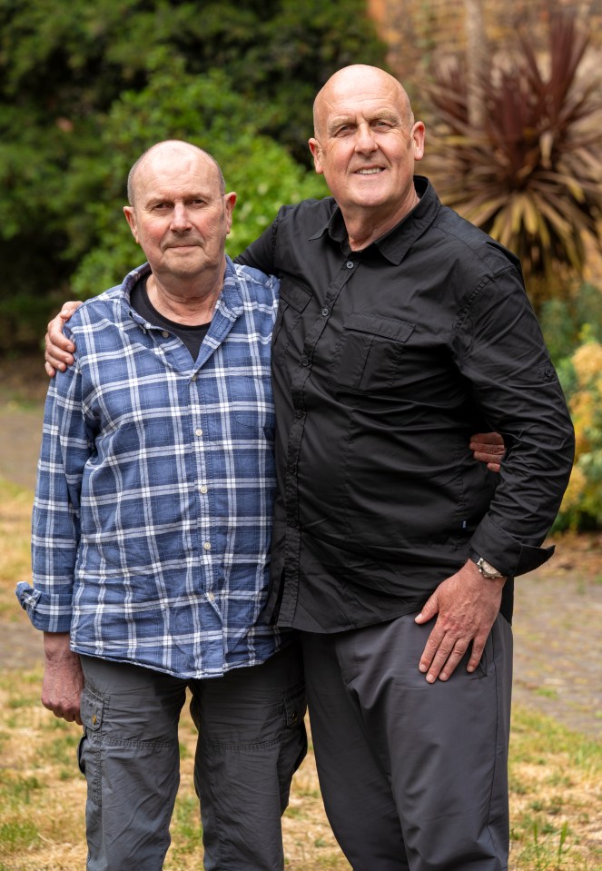 Two brothers posing for a photo; one in a black shirt, the other in a blue plaid shirt.
