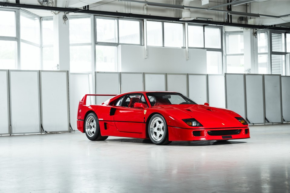 Red 1989 Ferrari F40 in a showroom.