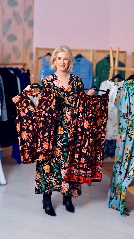 A celebrity stylist holds up two floral dresses.