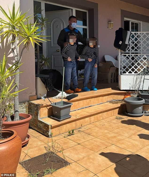 Two of the children are lead from the house in Spain after police intervened on Wednesday