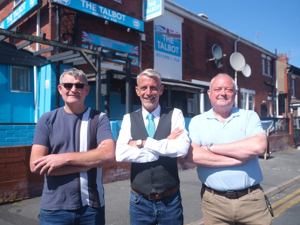 Three men stand in front of The Talbot Reform UK pub in Blackpool.