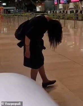 A woman was seen hunched over as she walked through the airport that is used by thousands of Brits