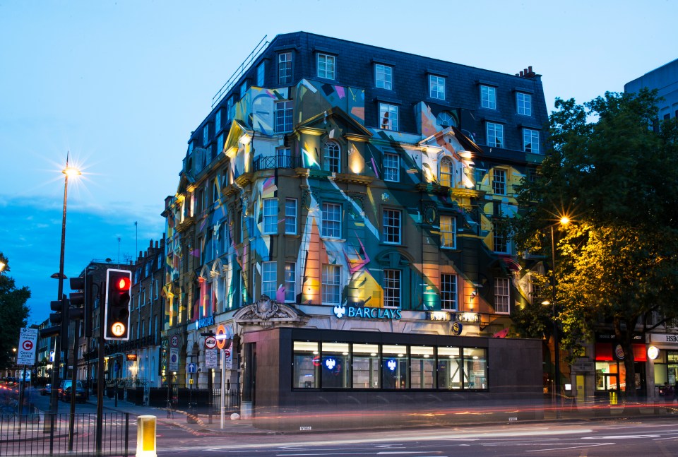 Megaro Hotel building at night with colorful artwork.
