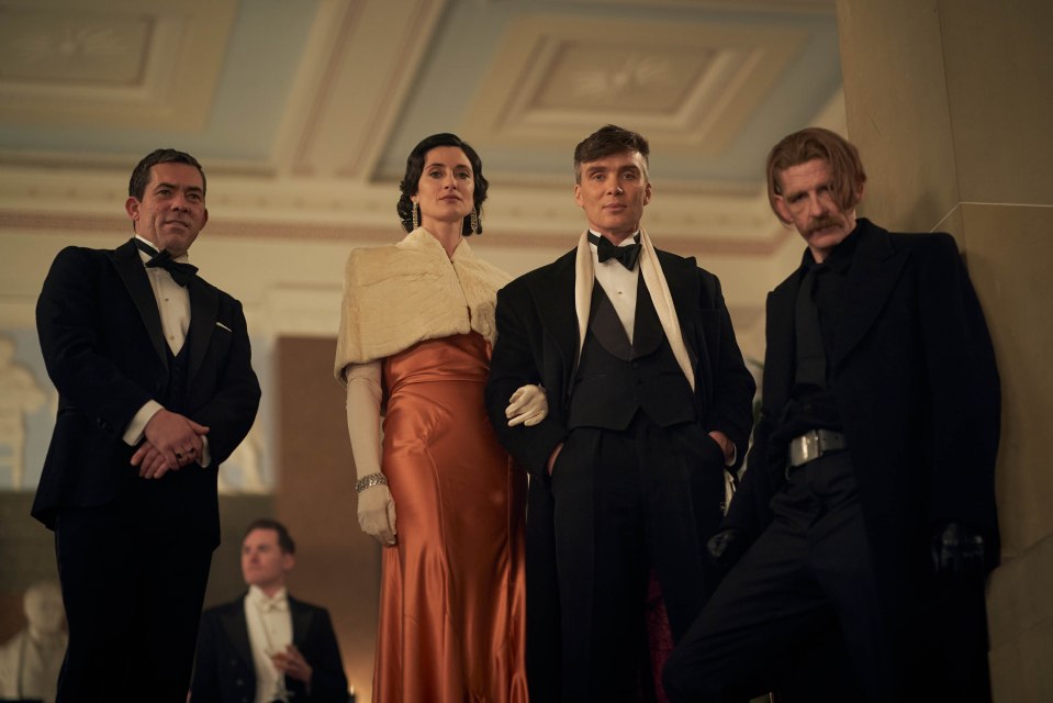 Scene from Peaky Blinders featuring four characters in formal attire.