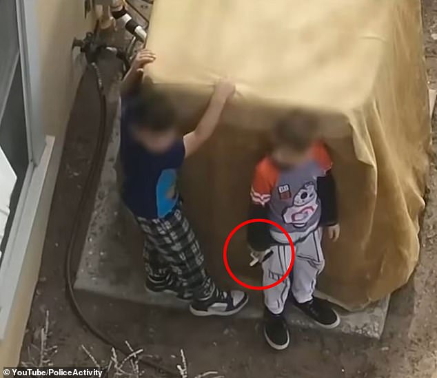 New Mexico police officers were forced to confront two young boys aged just seven and nine-years-old after they refused to drop a handgun
