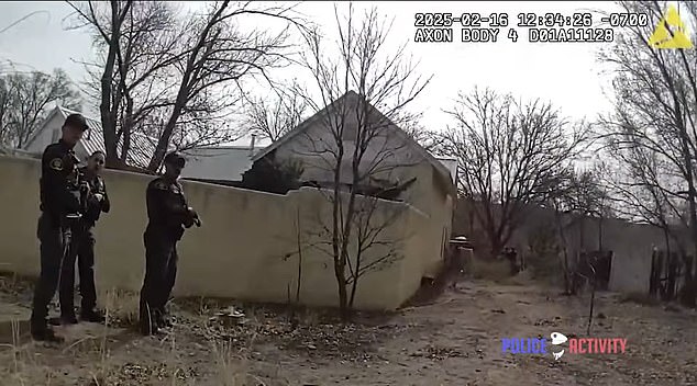 Officers could be seen attempting to diffuse the situation outside the perimeter wall of a home