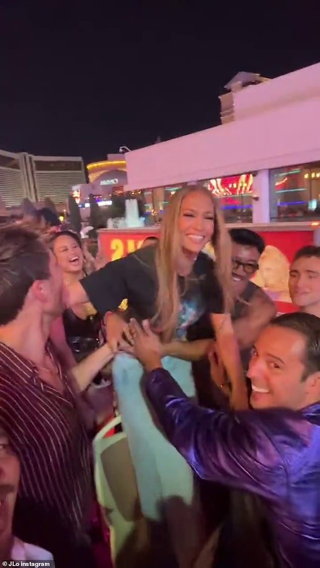 Jennifer Lopez, 55, shows no signs of stopping her latest wild antics as she was filmed partying on an open-top bus in Las Vegas on Monday - after her shock lesbian kiss at AMAs