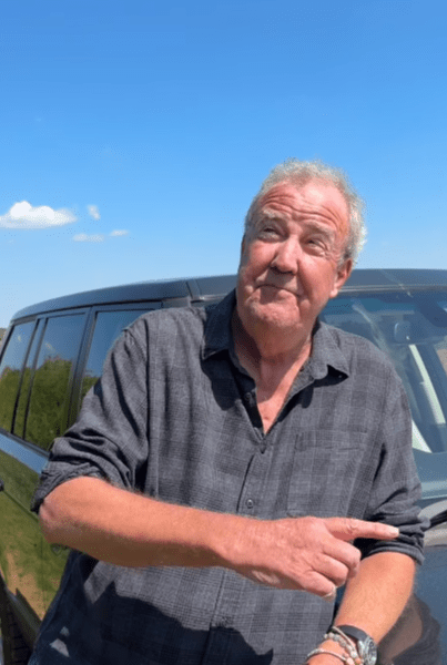 Jeremy Clarkson standing next to a car, pointing.