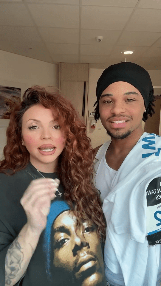 Jesy Nelson and a man, possibly her running partner, speak to the camera.  The man is wearing a white shirt and a running bib.
