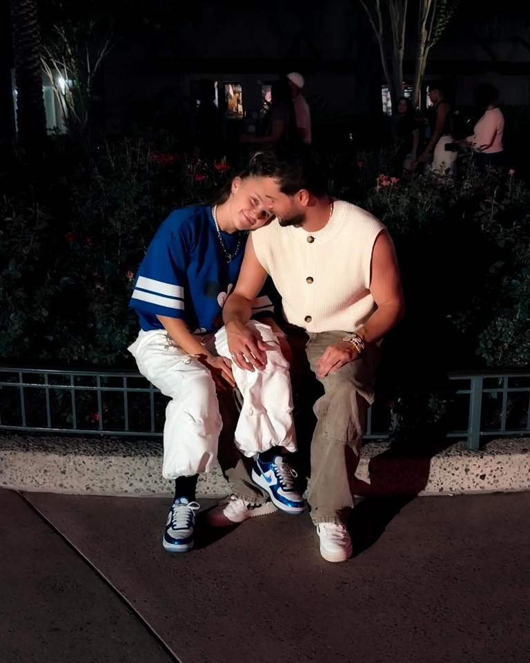 Couple sitting close together at night.