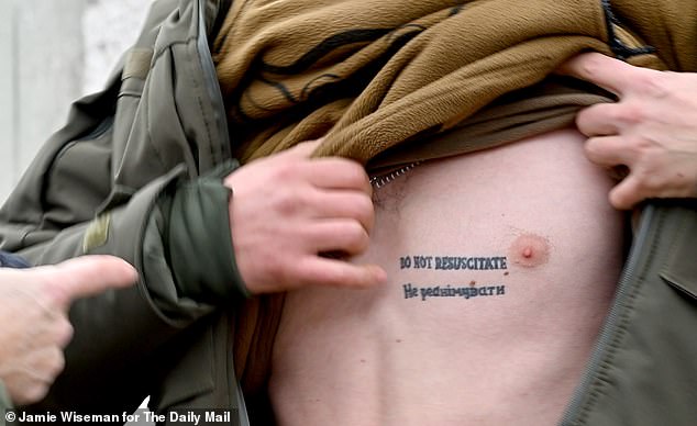 Lieutenant Illia of the 2nd Battalion, 37th Separate Marine Brigade, a young frontline medic who says he's had to carry out over 180 limb amputations. He shows his 'do not resuscitate' tattoo