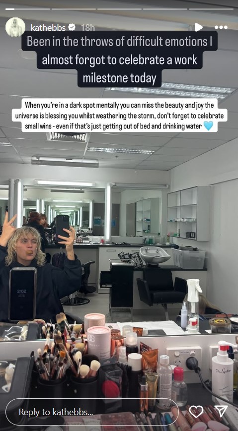 Woman celebrating a work milestone in a makeup room.