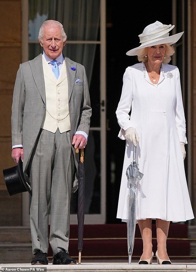 King Charles and Queen Camilla are pictured attending the Education and Skills Garden Party at Buckingham Palace on Wednesday afternoon