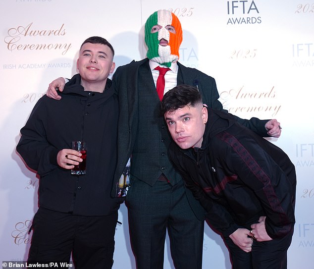 O'Hanna, 27, who performs under the stage name Mo Chara, is alleged to have displayed the flag showing the terrorist group while the controversial Irish rap group perfromed at the O2 Forum in Kentish town last year. Pictured: O'Hanna, left, with bandmates DJ Provai and Moglai Bap