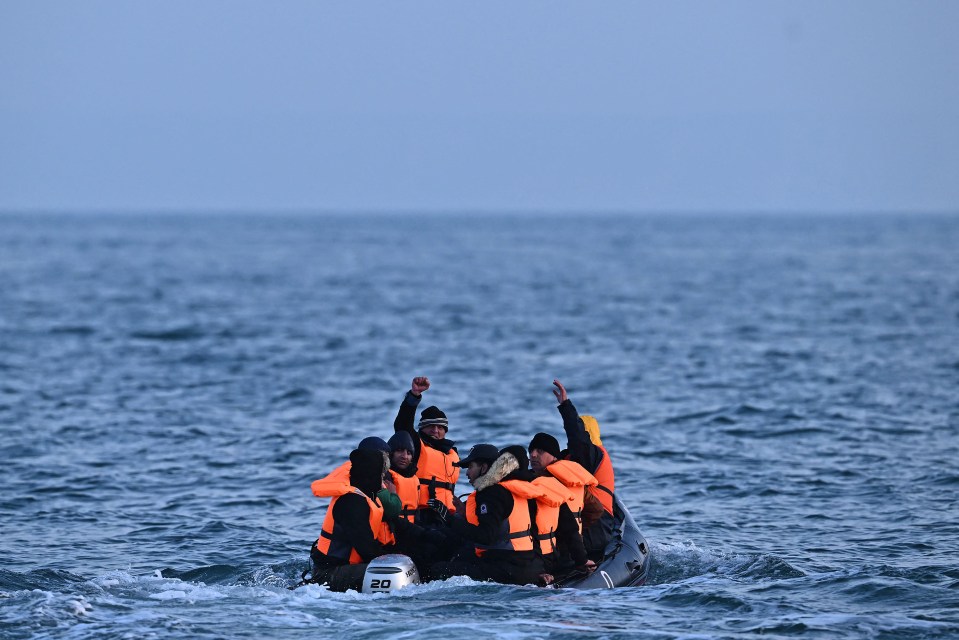 Migrants in a small boat at sea.