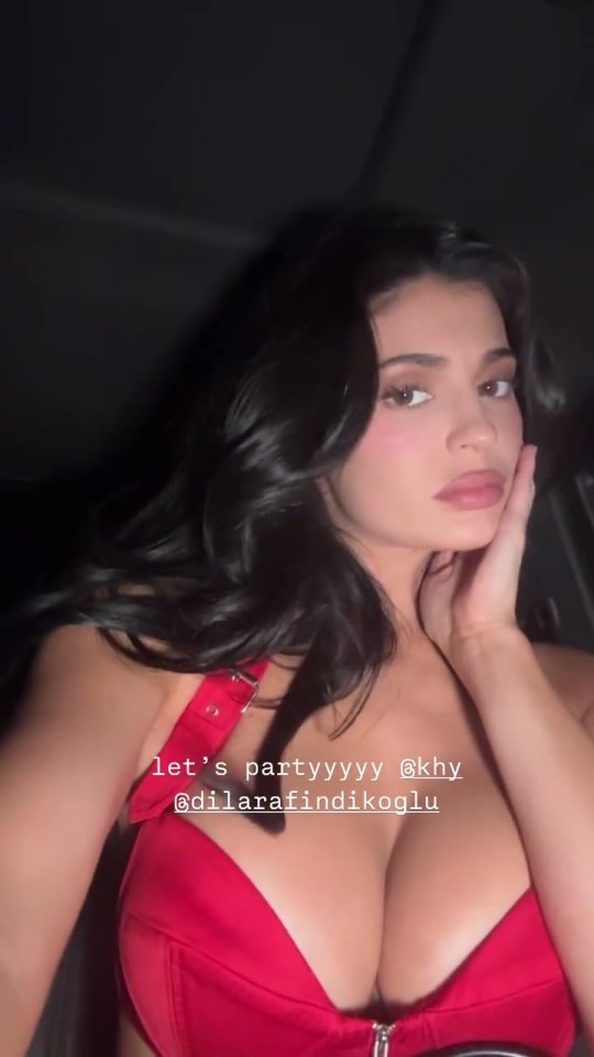 Kylie Jenner at a party wearing a red top.