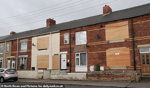 Furious residents living on an 'eyesore' ghost street earmarked for demolition vowed they would 'rather be shot' than give up their beloved homes