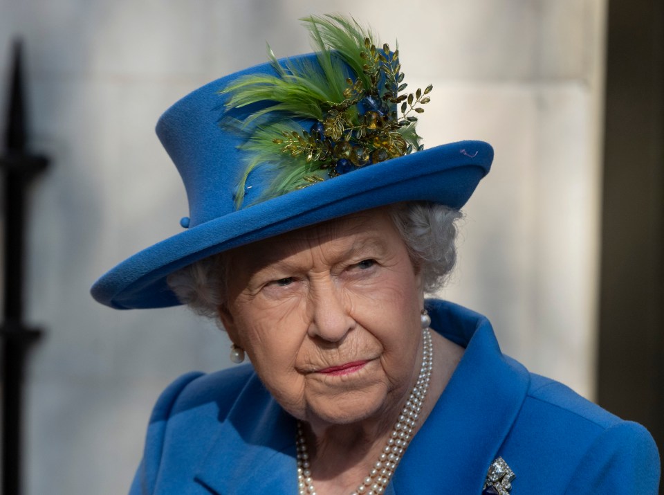 Queen Elizabeth II wearing a blue coat and hat.