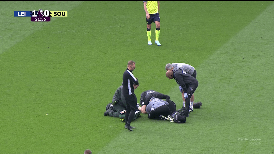 Injured soccer player receiving medical attention on the field.