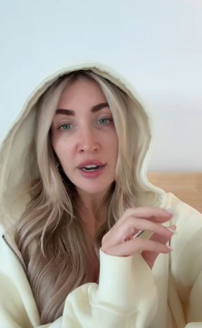 Kate Cassidy in a cream hoodie.