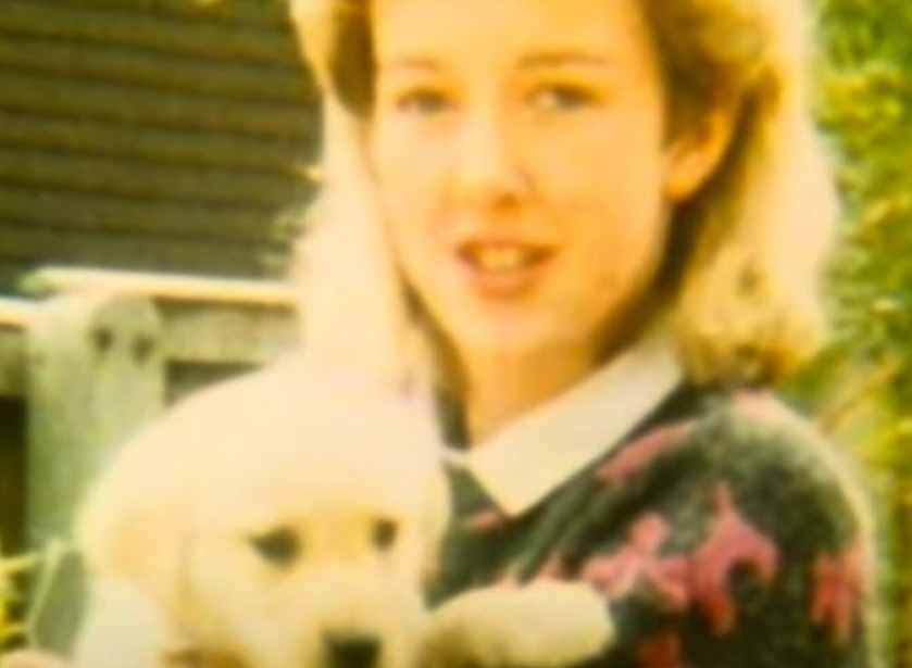 Photo of Diane Sindall holding a puppy.