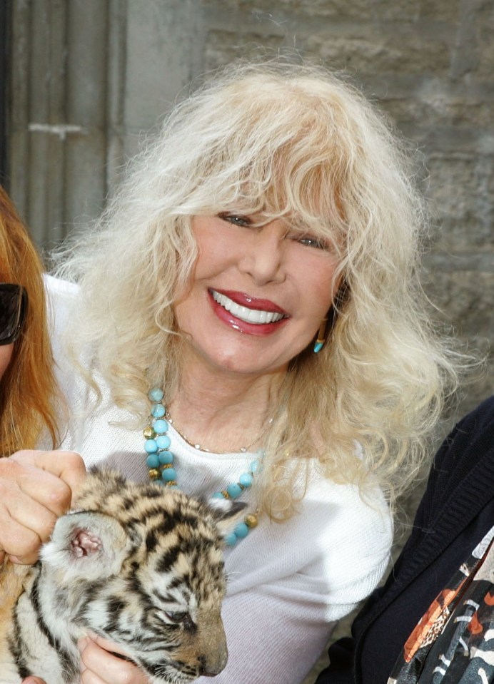Martine Collette holding a tiger cub.