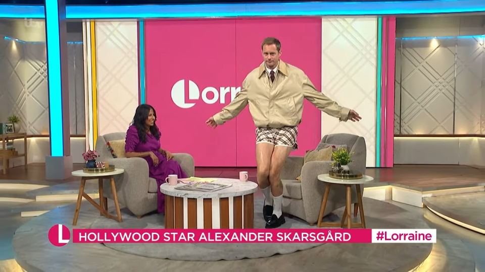 Alexander Skarsgård in shorts and a jacket on a talk show.