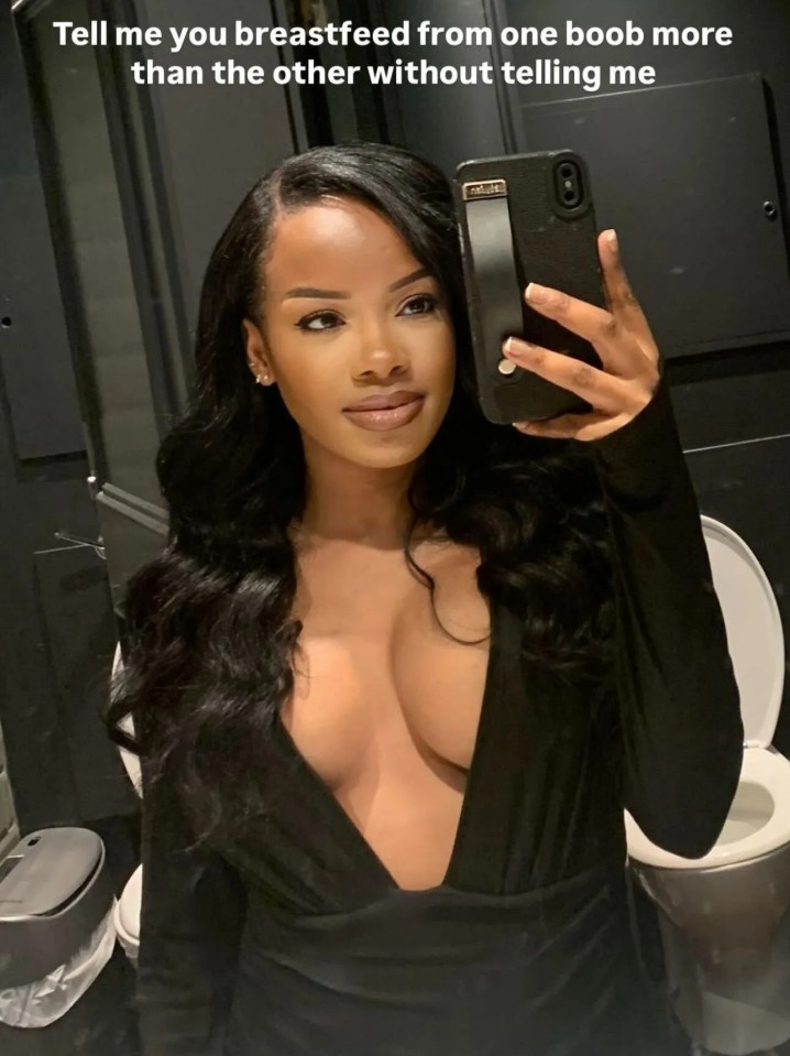Woman taking a selfie in a low-cut black dress.