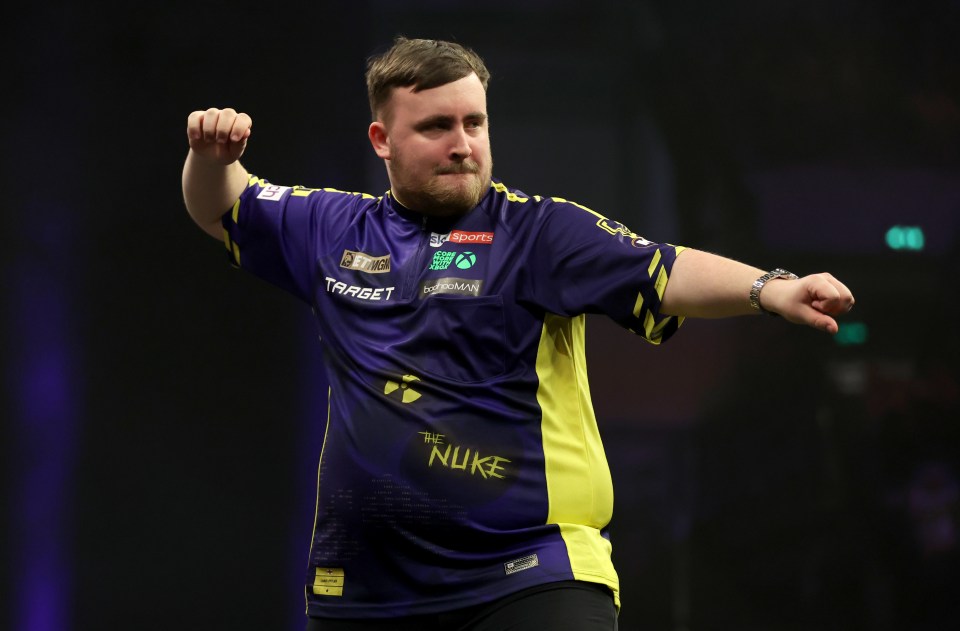 Luke Littler reacting during a darts match.