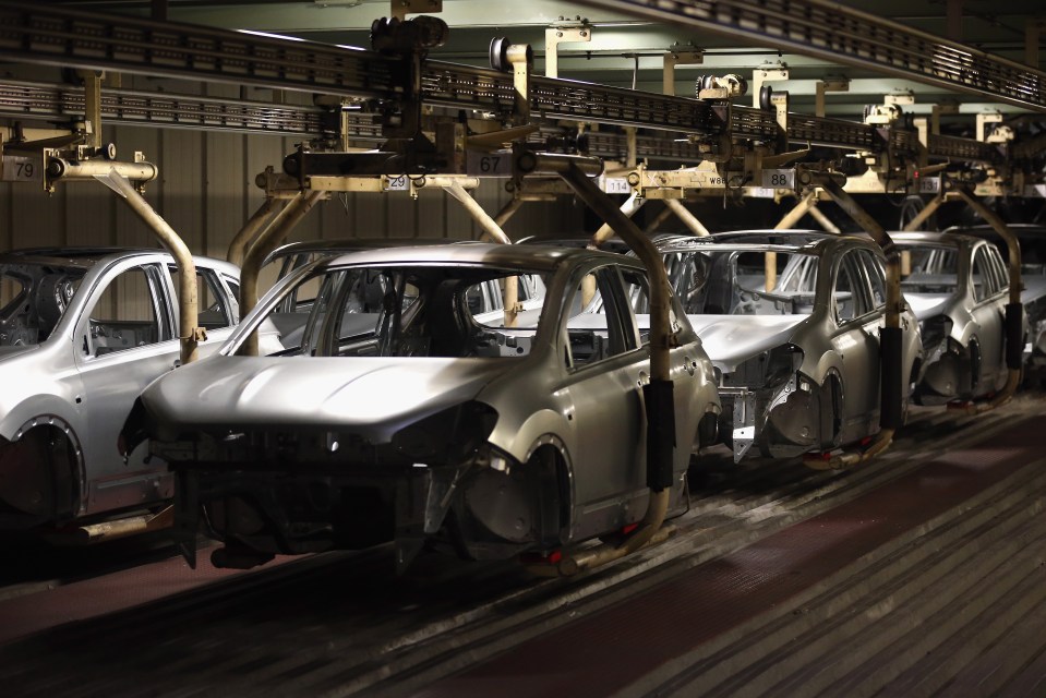 Nissan vehicles undergoing final inspection on a production line.