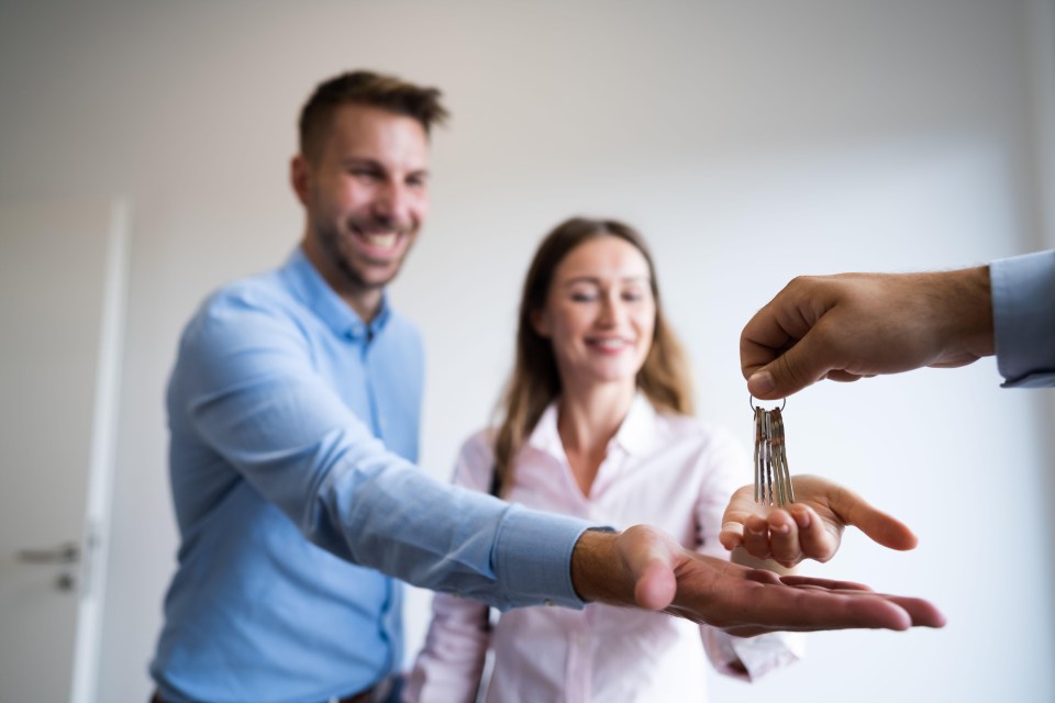 A couple receiving house keys.