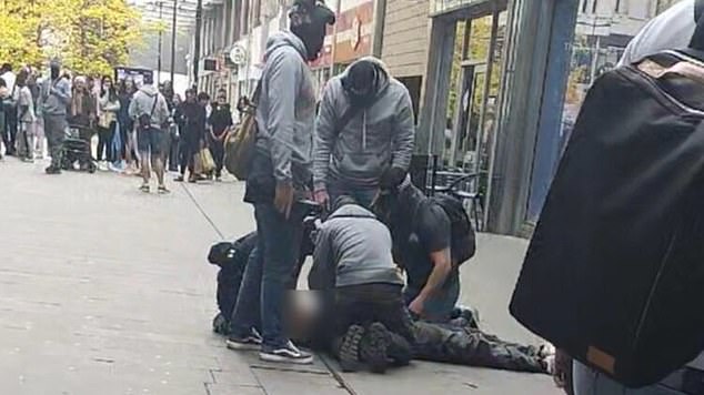Police and MI5 have foiled a suspected plot by Iranian terrorists to carry out a major attack in Britain. Counter-terror officers and Special Forces raided two suspected Iranian cells in a 'highly significant' operation to tackle growing activity by the hostile state in the UK. Pictured: Plain-clothed cops searched one of the suspects in Swindon town centre