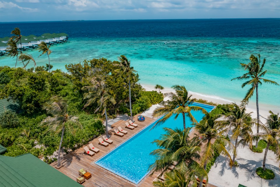 Aerial view of a resort pool in the Maldives.