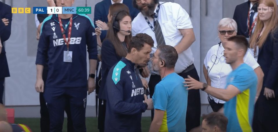 Two soccer coaches arguing on the sidelines.