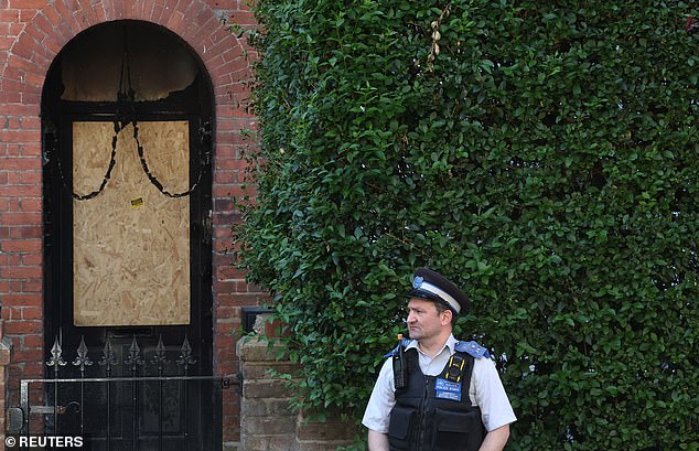 A police officer stands outside Prime Minister Keir Starmer's private home that was damaged in a fire